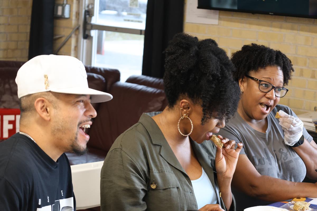 The three judges laughing mid-taste