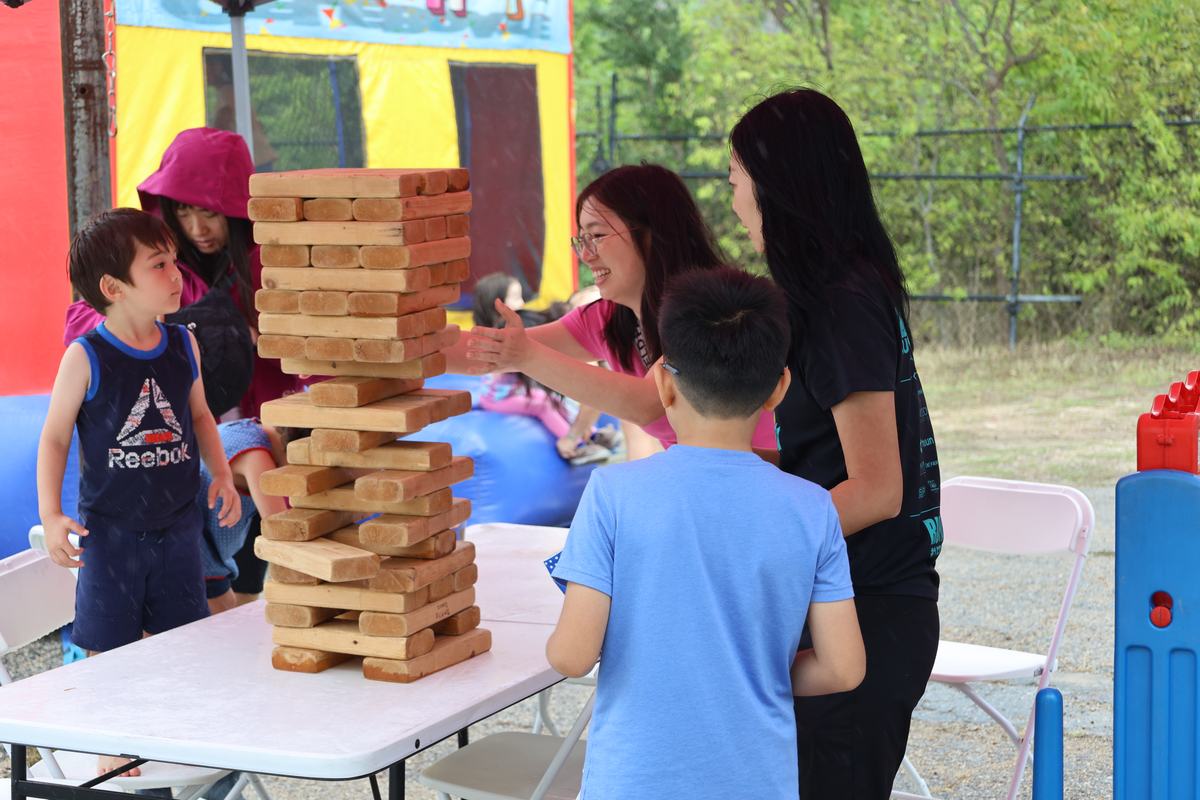 Kids playing giant Jenga out back